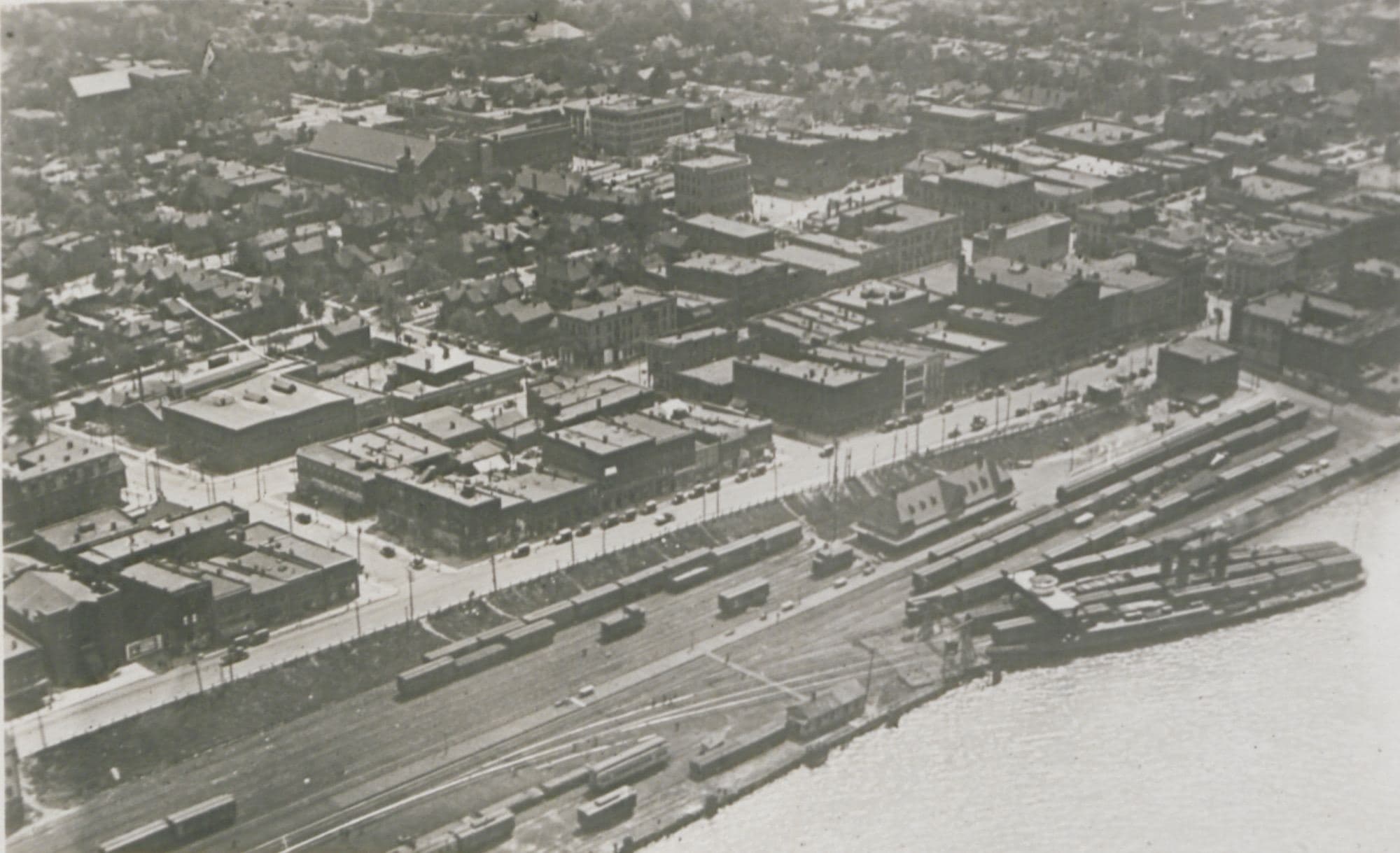 Windsor, Ontario, from the air in 1920 — the river, the rail yards and the downtown blocks, in the year the town chartered the first Lions club outside the United States.